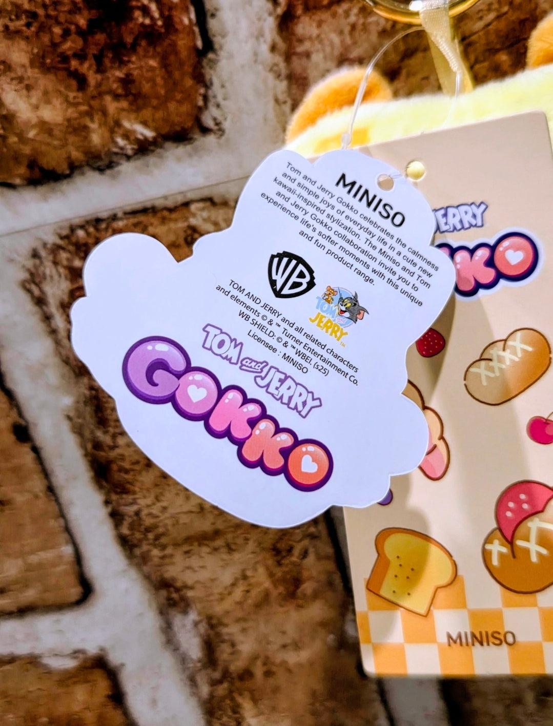 Tom and Jerry-themed plush keychain hangtag with MINISO branding and icon graphics