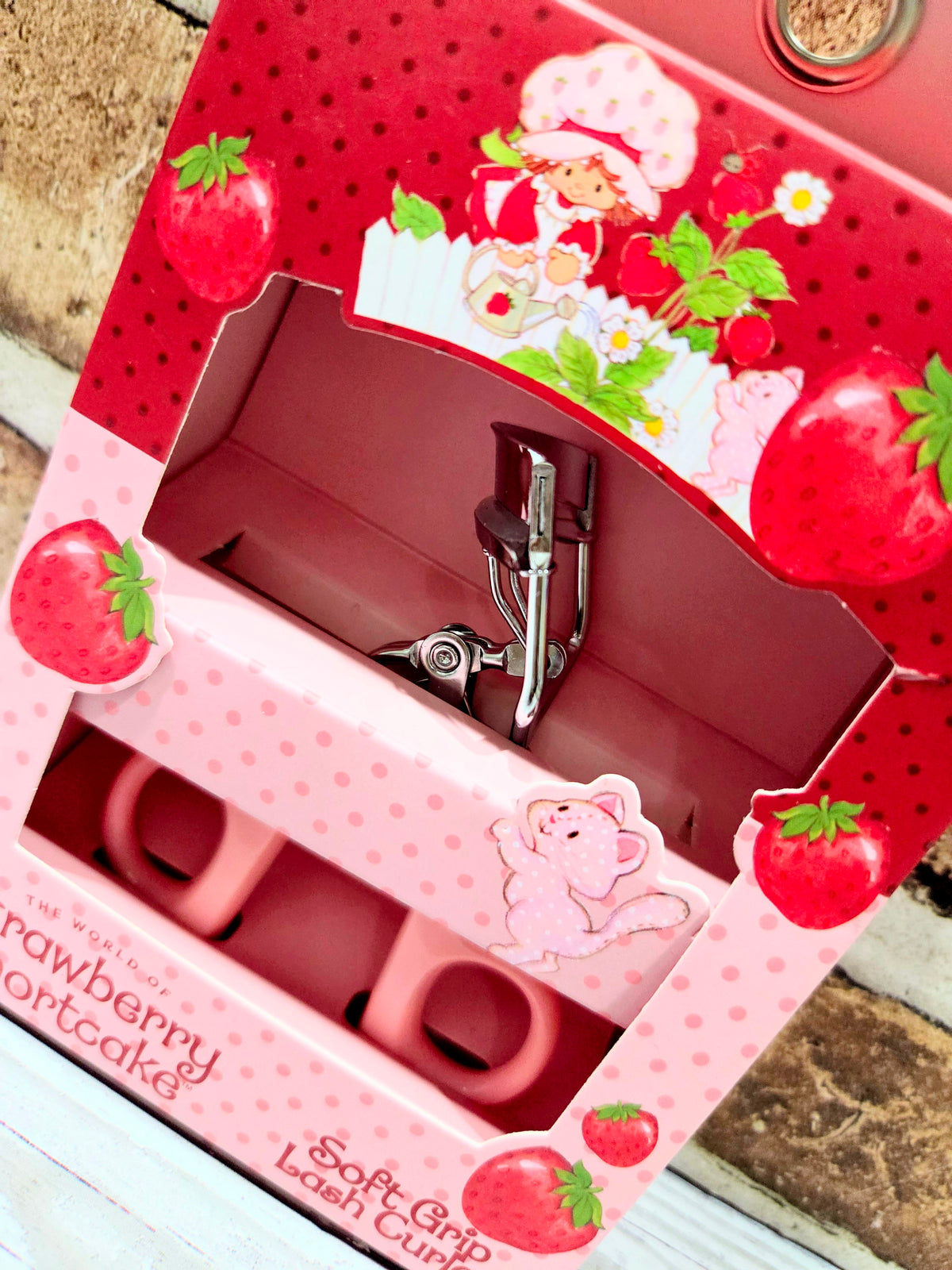 Pink strawberry eyelash curler display tray with metal clamp and inner holder