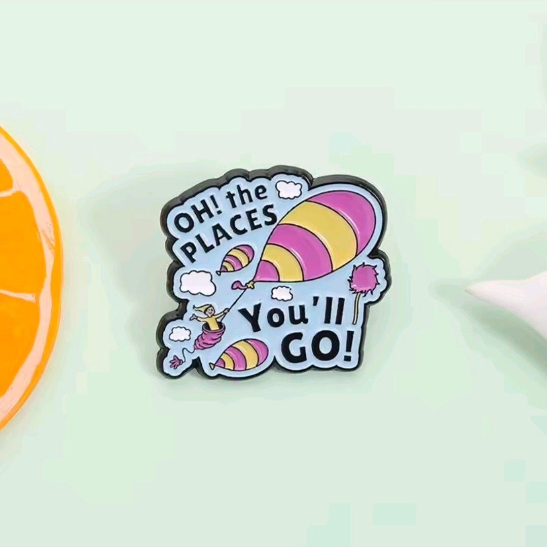 Oh the Places You'll Go! colorful enamel pin on light background.