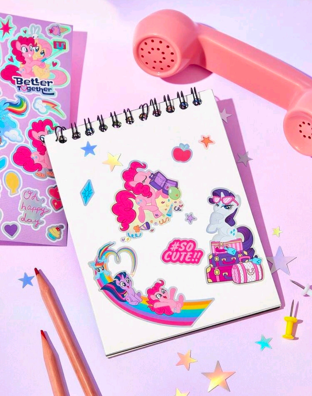 Holographic foil pony stickers on a spiral notebook planner page