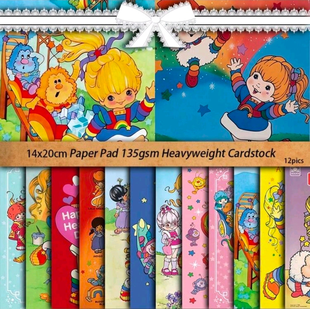 Rainbow Brite paper pad with colorful character designs, stacked sheets with 12 pack text