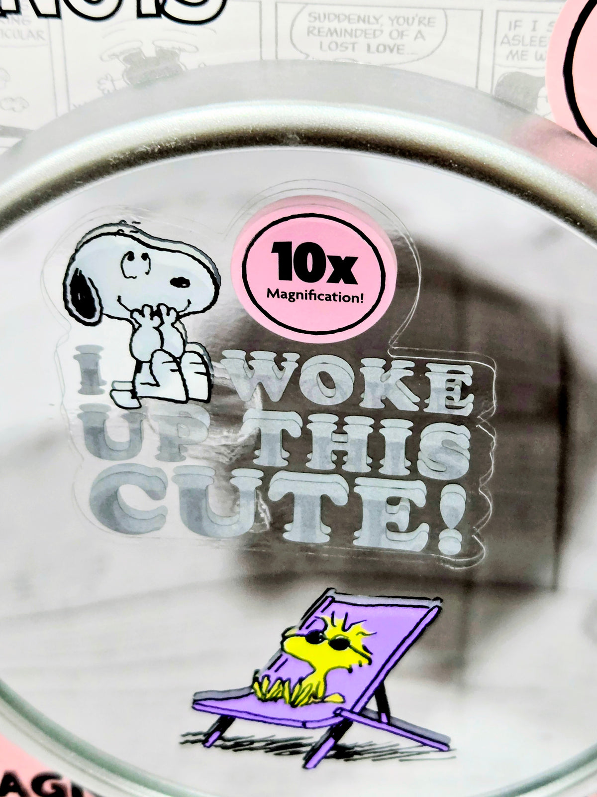Round Snoopy magnifying mirror lens with 10x badge and 'Woke Up This Cute!'