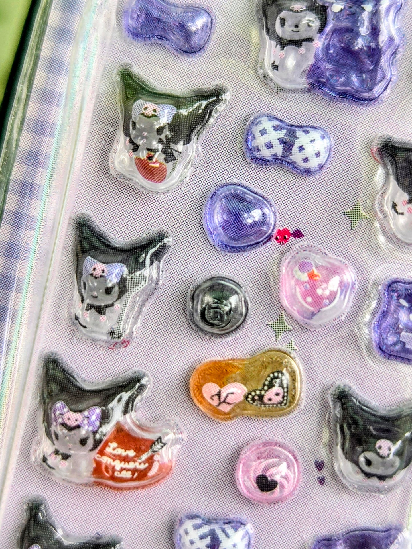 Sanrio 3D sticker set with animal and heart-shaped charms in purple, pink, and green.