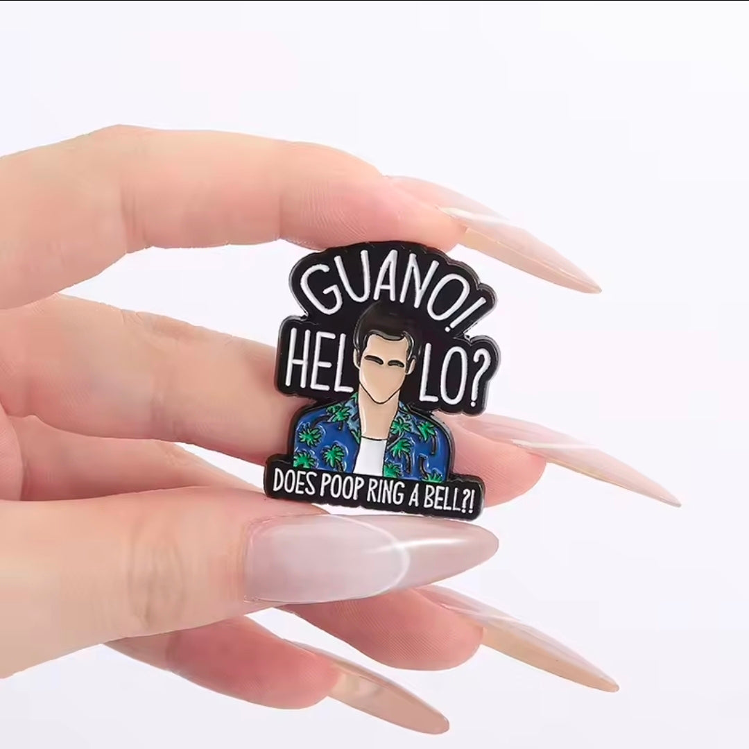 Enamel pin held in hand: “GUANO! HELLO? DOES POOP RING A BELL?!” text