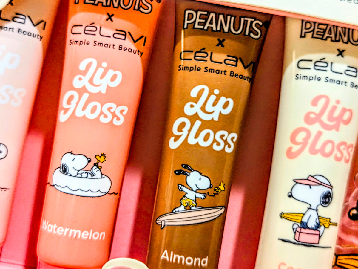 Close-up of lip gloss tubes labeled Watermelon, Almond, and Coconut with Peanuts art