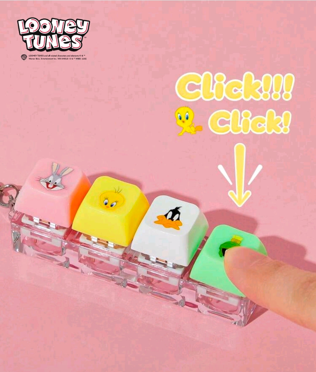 Looney Tunes clicker fidget keychain row of four keycaps pressed by a hand, clear base