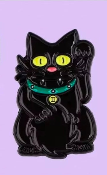 Black cat enamel pin with bright yellow eyes and teal collar
