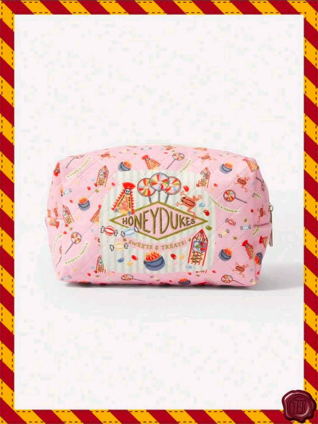 Pink Honeydukes makeup pouch with front print and rounded rectangular shape