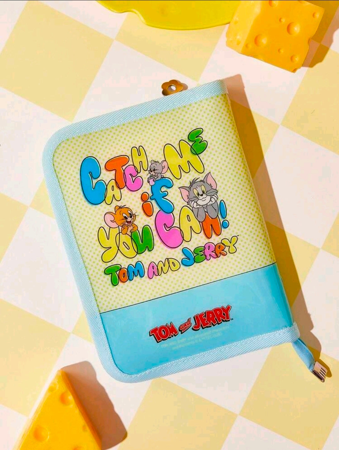 Light blue zipper planner binder with Tom and Jerry cartoon cover and rounded edges.