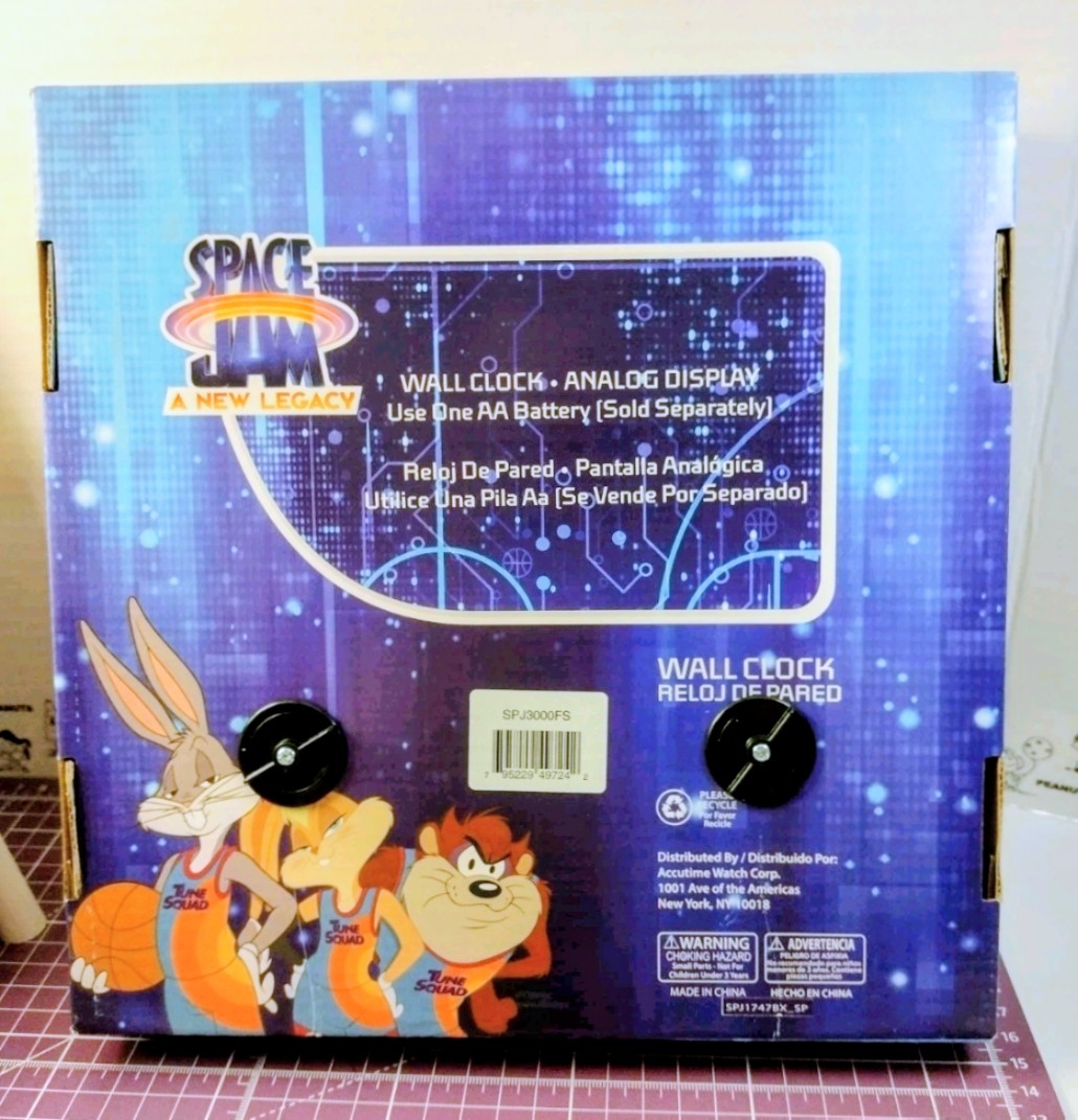 Space Jam wall clock in box with purple cosmic artwork and character graphics