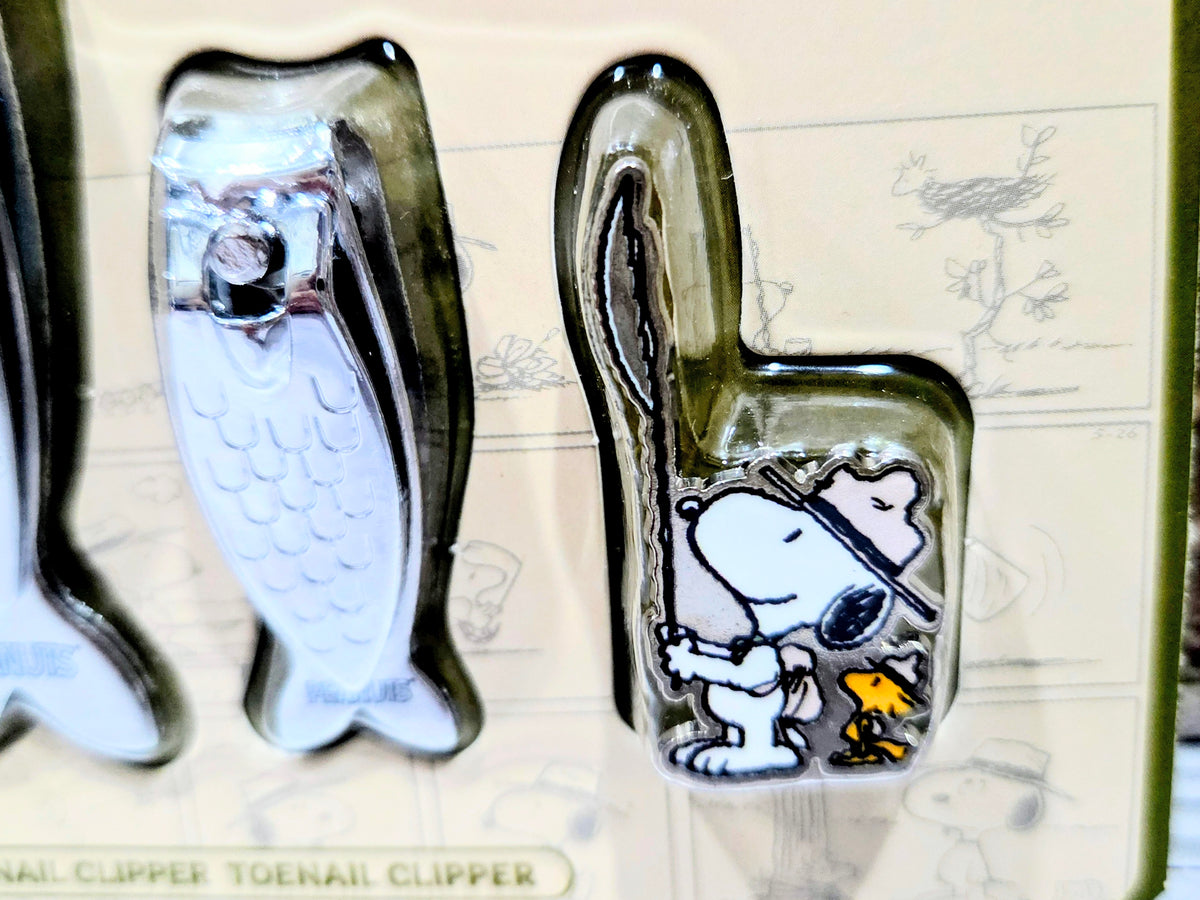 Fish-shaped nail clippers with two Snoopy fish pieces and a Snoopy pin accessory