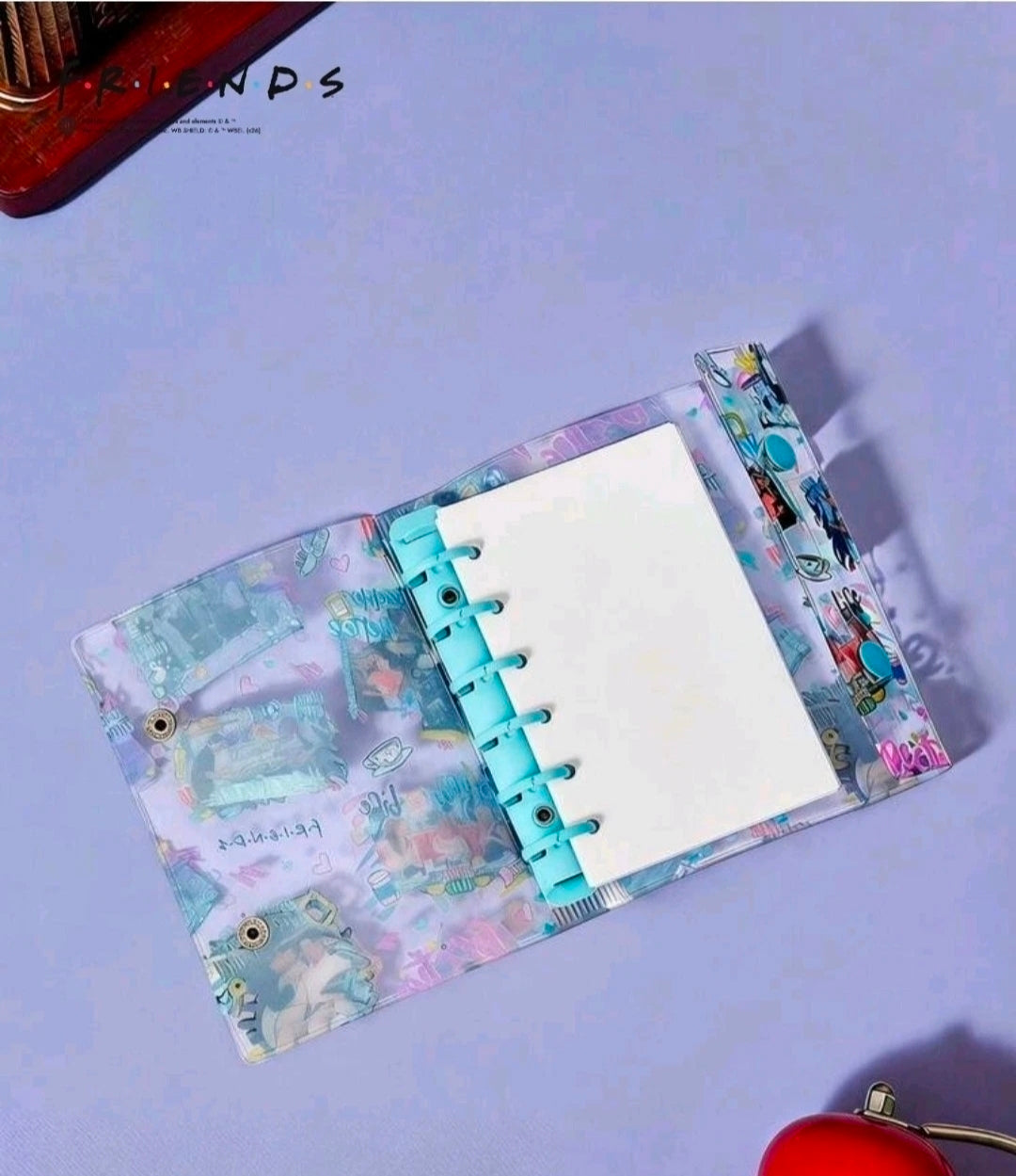 Open ring binder planner with blue-toned graphic cover and visible binder rings
