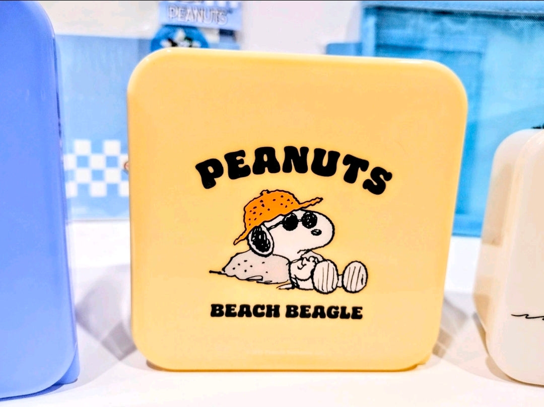 Yellow mini storage tin with “PEANUTS BEACH BEAGLE” graphic