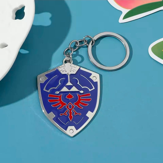 Blue shield enamel keychain with silver chain and split ring, red Triforce emblem