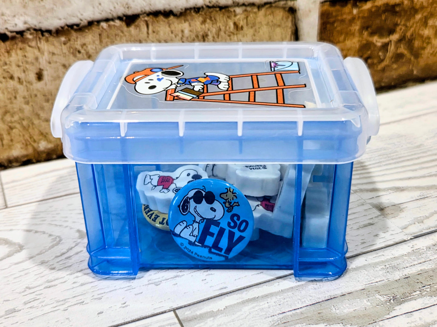 Mini desktop organizer box with Snoopy erasers and round "So Fly" badge