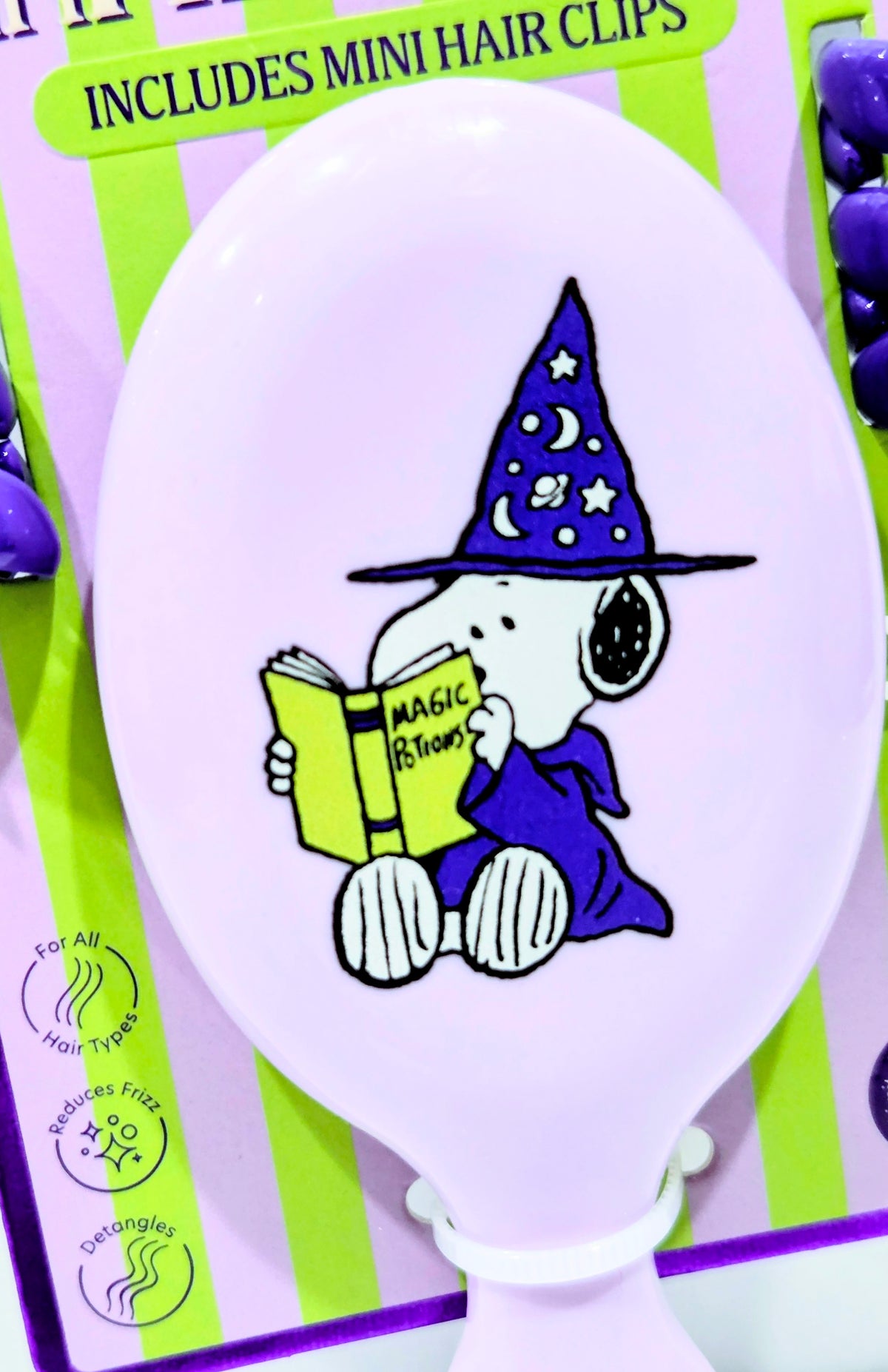 White mini hairbrush featuring wizard Snoopy illustration on rounded face