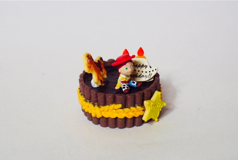 Western birthday cake mini figure with cowboy character and 'Happy Birthday' sign