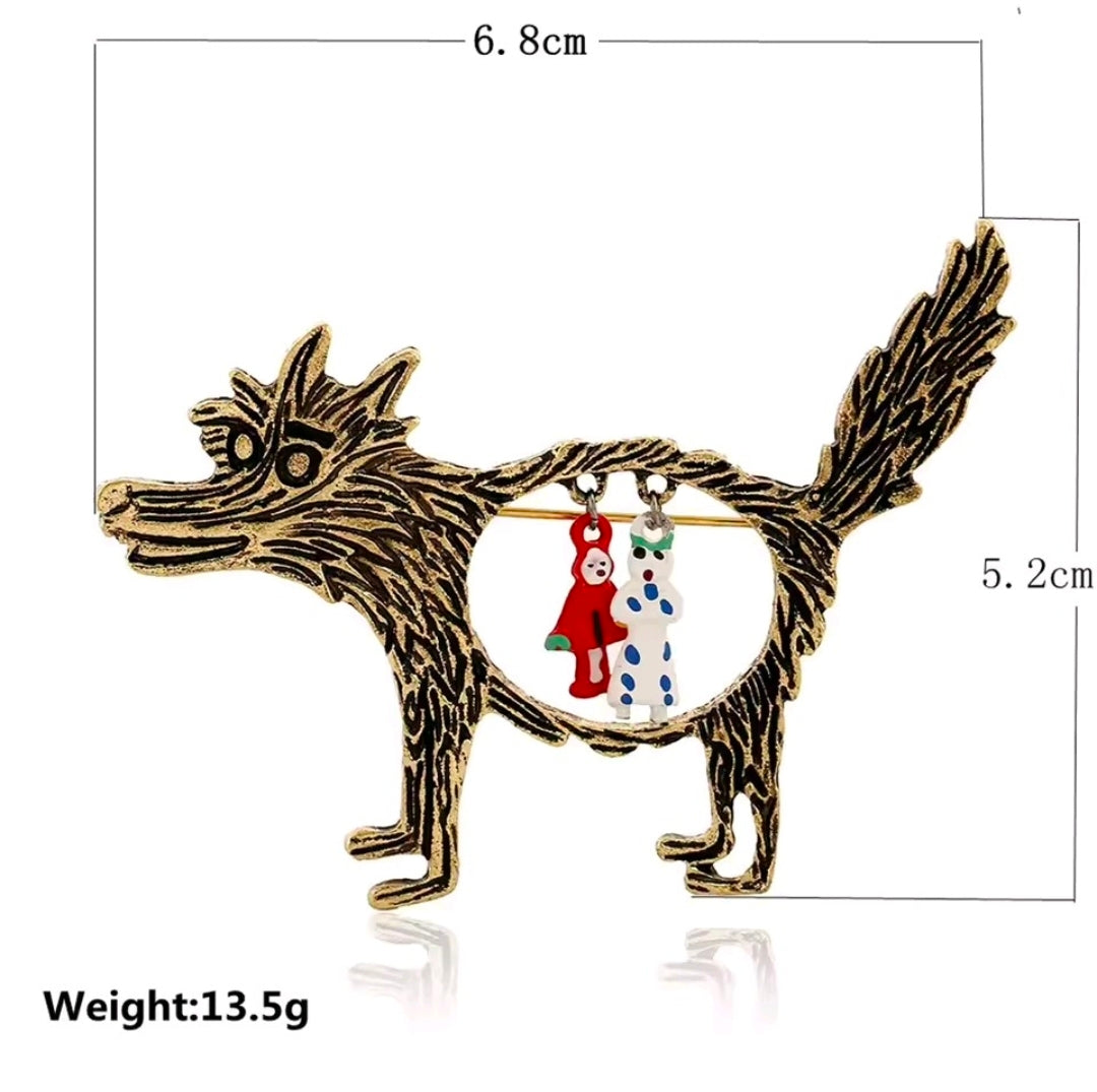 Enamel wolf brooch pin with circular Red Riding Hood and grandma charms, gold-tone.