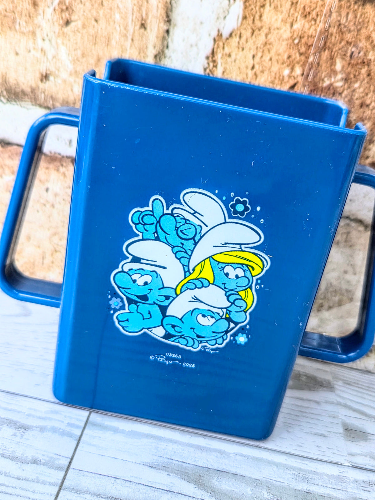 Smurfs blue juice box holder with cartoon Smurfs graphic on the front