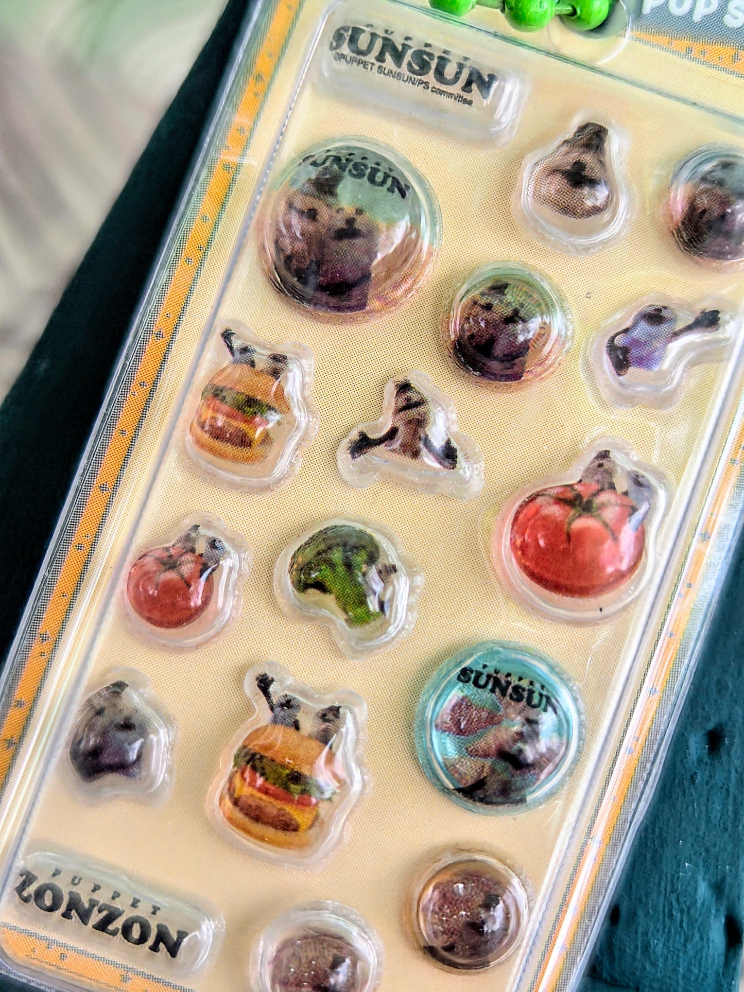 Close-up of clear blister sticker keychain pack with small round animal-themed stickers