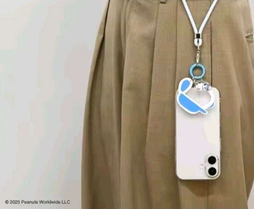 Snoopy carabiner keychain with blue charm hanging from bag strap