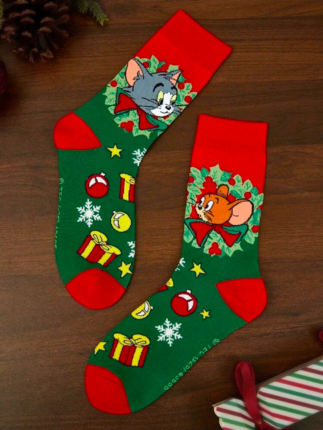 Holiday crew socks, green with red toes and cuffs, featuring festive cartoon prints