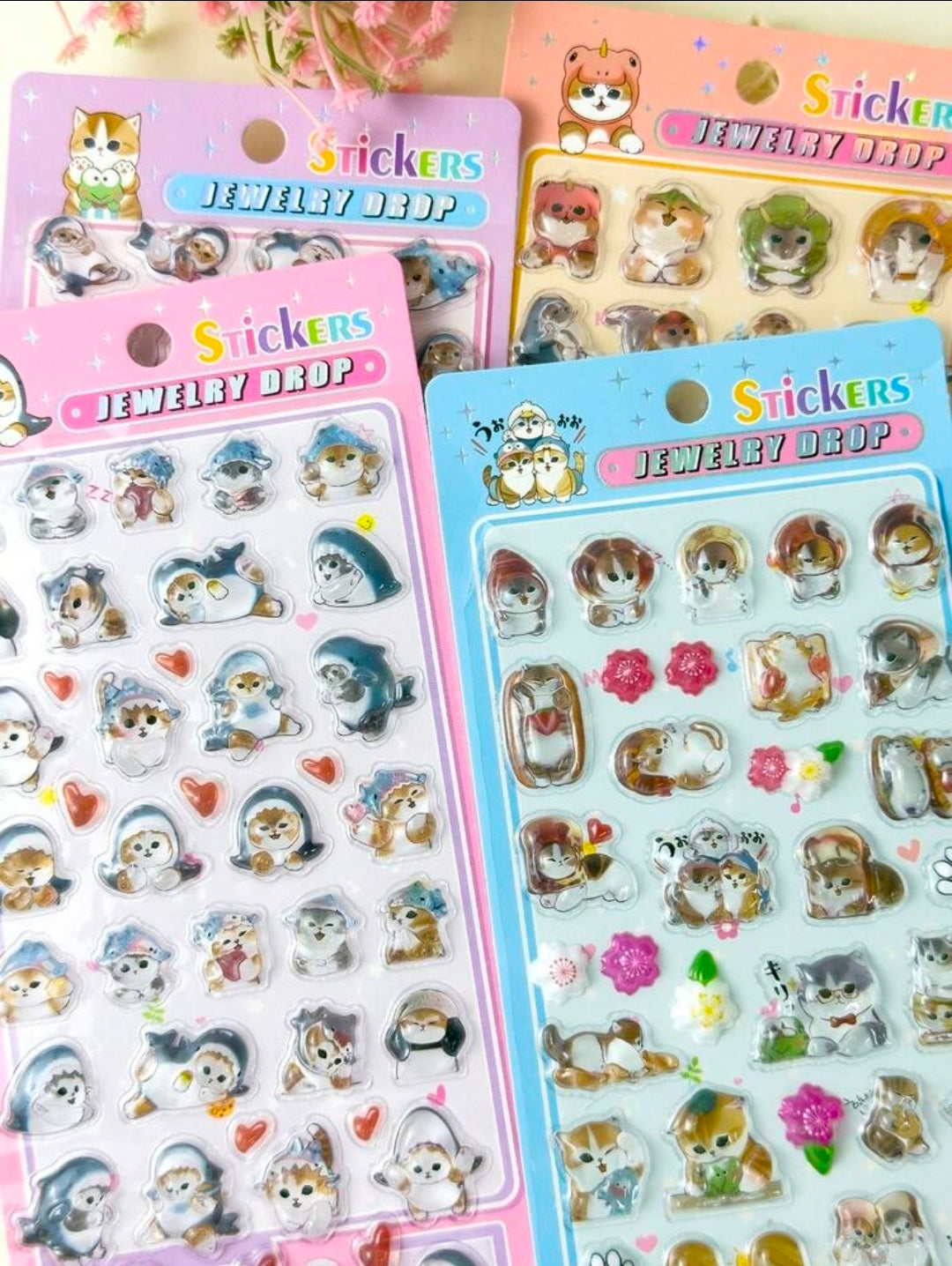 Cat jewelry drop puffy sticker sheet, blue and orange packs with cat, heart, and charm stickers