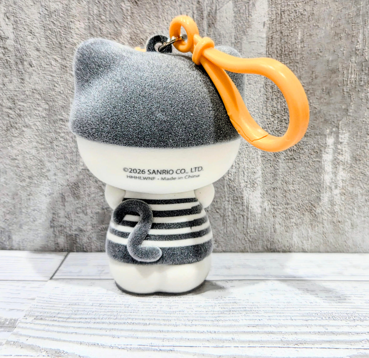 Grey striped felt cat bag clip/hanger with orange loop and white base