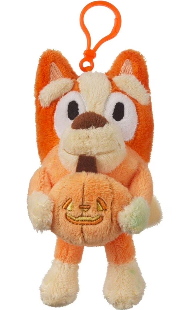 Orange Halloween plush keychain with jack-o'-lantern grin on belly and curled ears