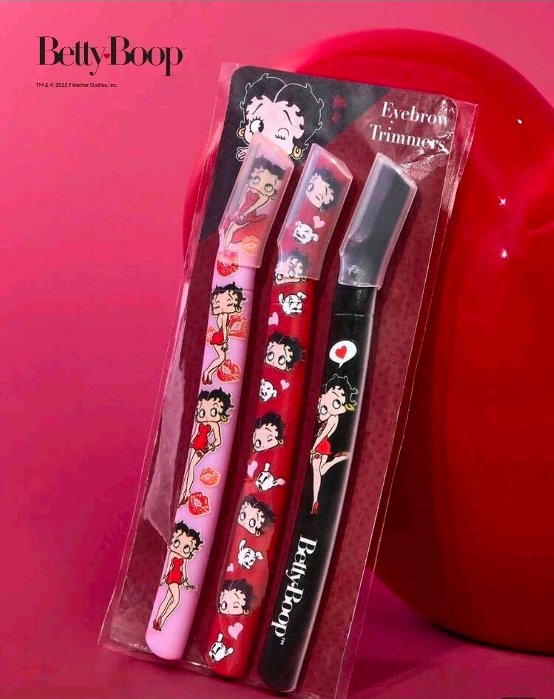 Betty Boop eyebrow trimmers set in clear blister, pink and red handles plus black trimmer
