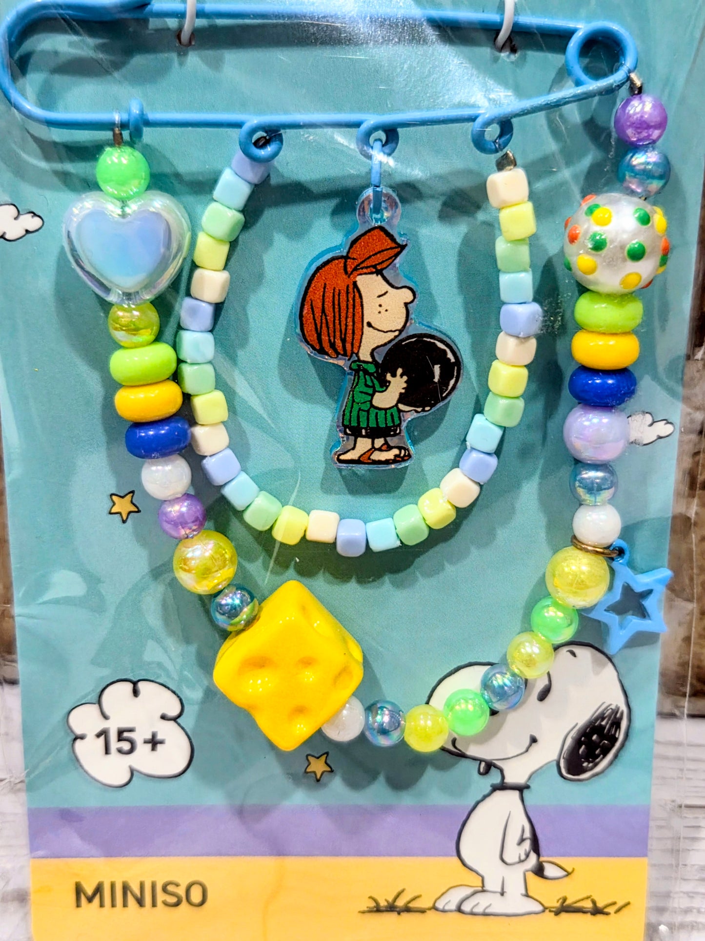 Sally beaded safety pin keychain with multicolor beads, heart charm, and star accents