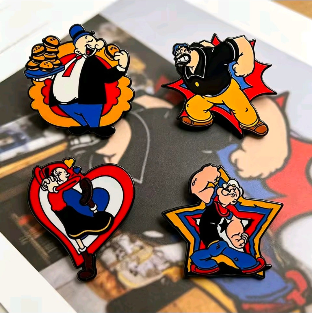 Four cartoon enamel lapel pins on a collage card: Popeye, Brutus, Olive Oyl, Wimpy.