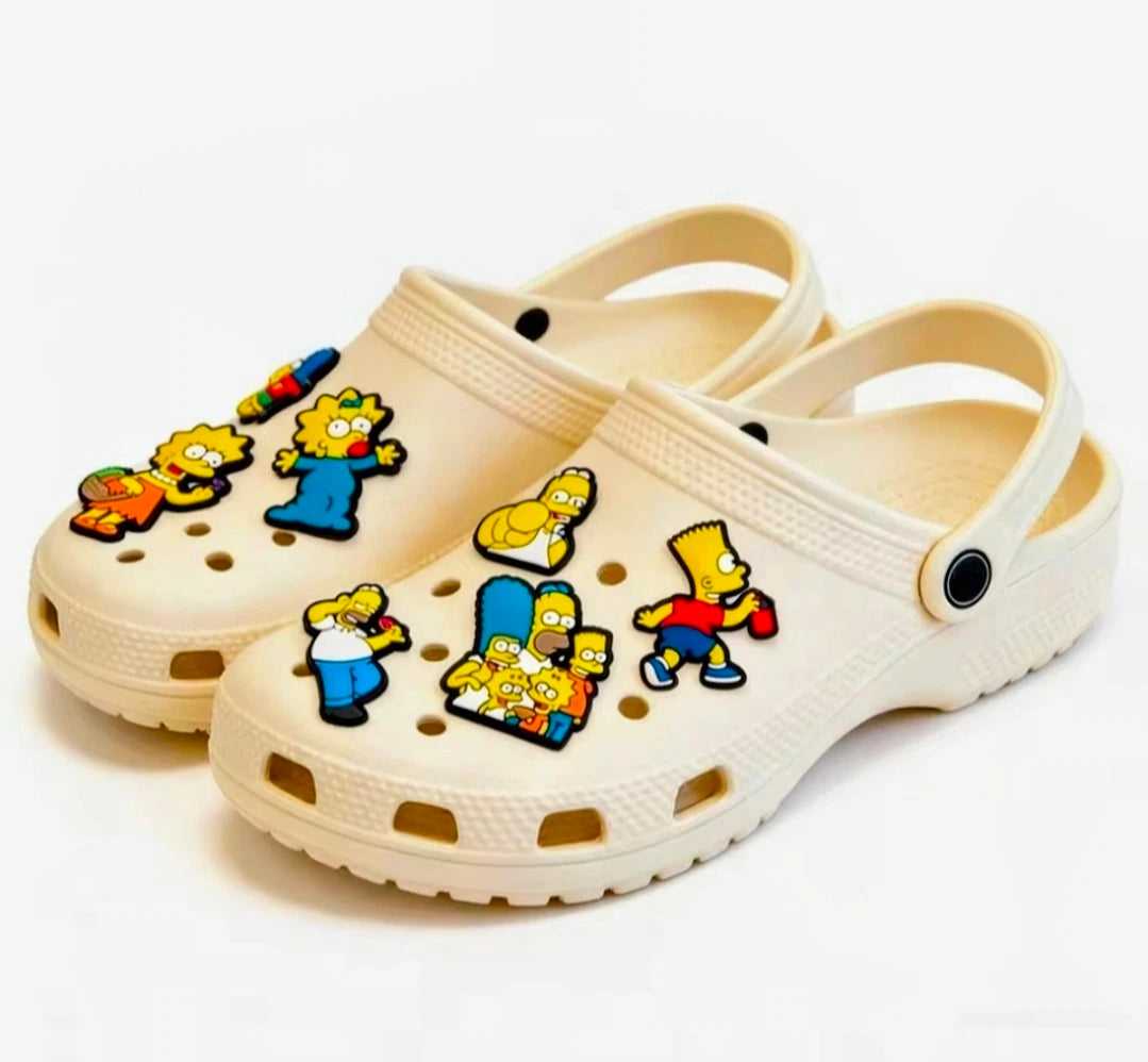 Cream clogs with Simpsons cartoon shoe charms pins