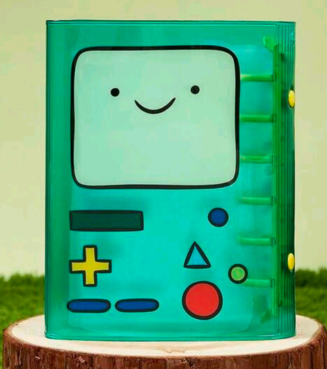 Green A7 mini binder featuring BMO face and colorful controller buttons on front.